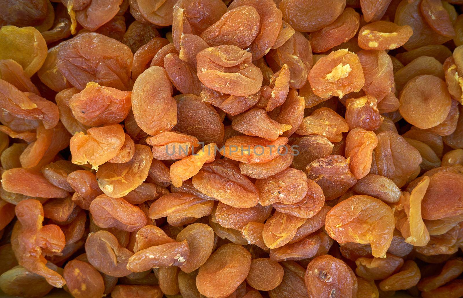 Dried apricot fruit forming a background.Group of dried fruits of apricot, close up