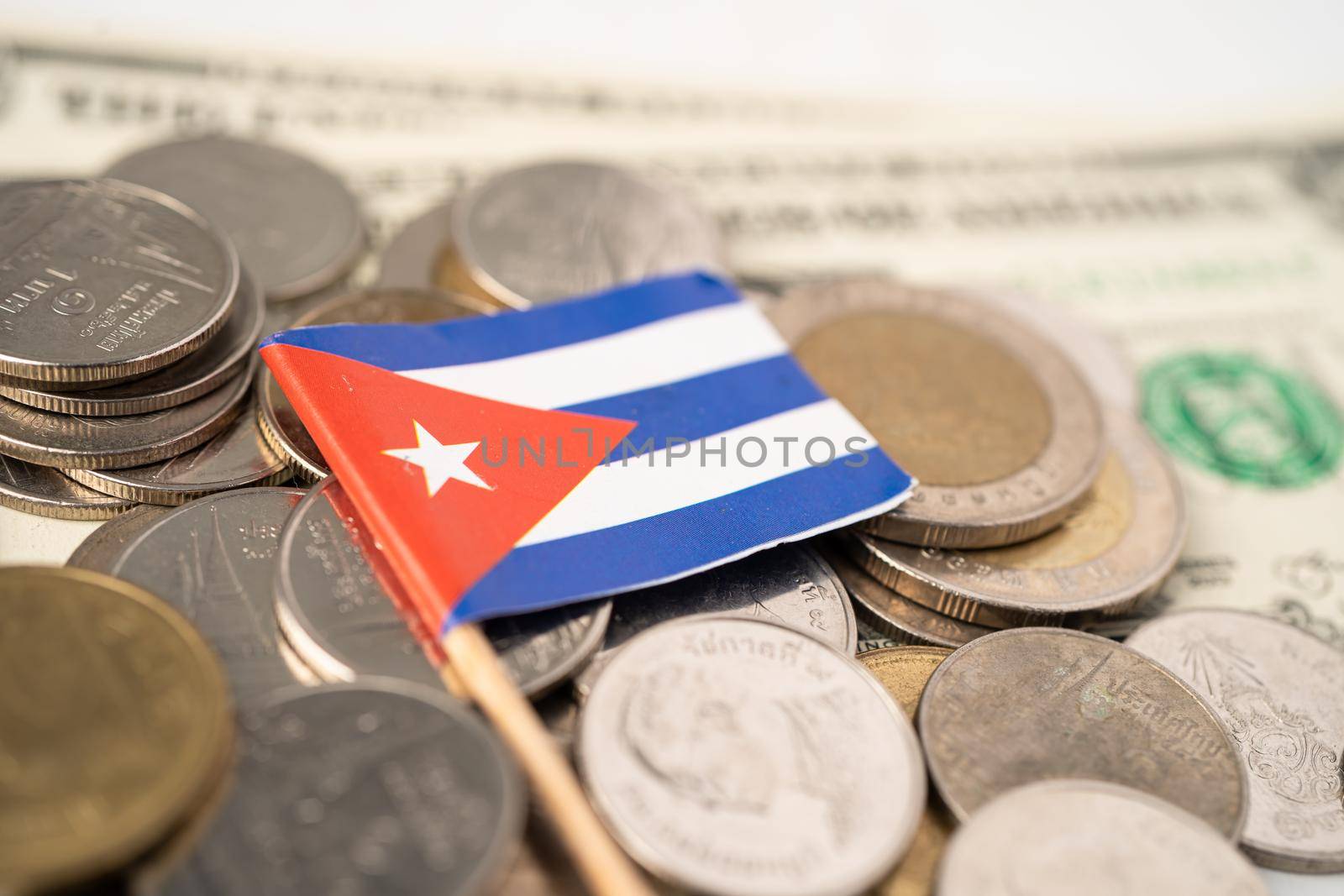 Stack of coins with Cuba flag on white background.