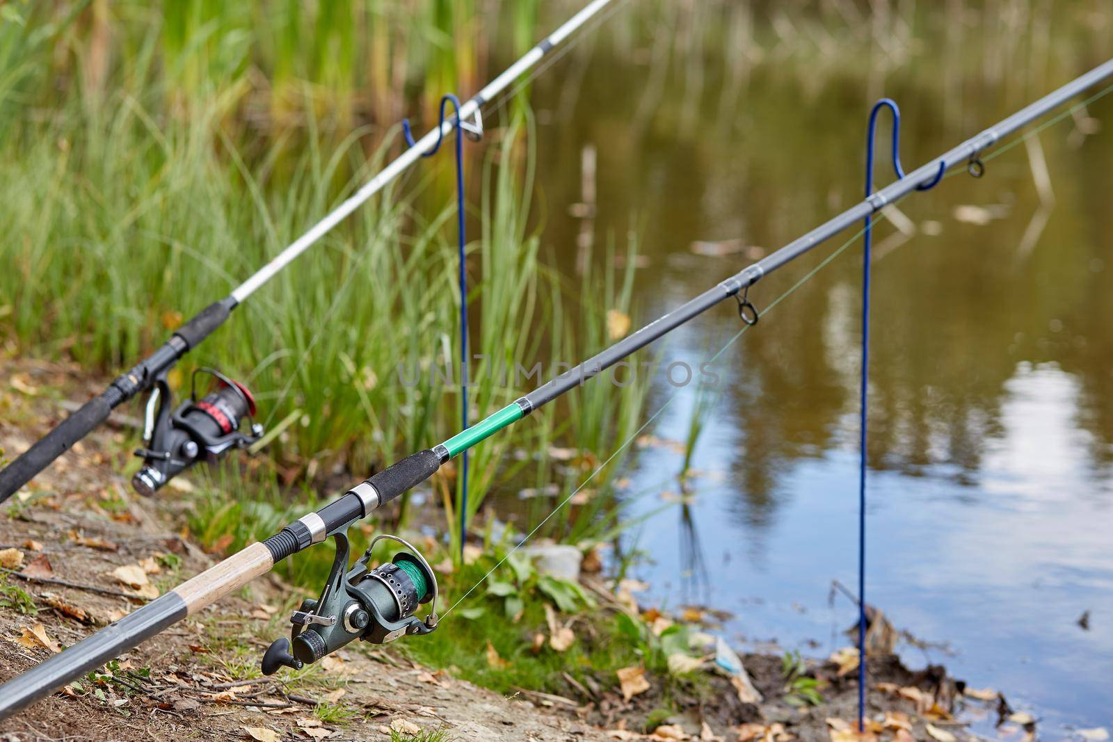 Fishing rod closeup on a prop and water background