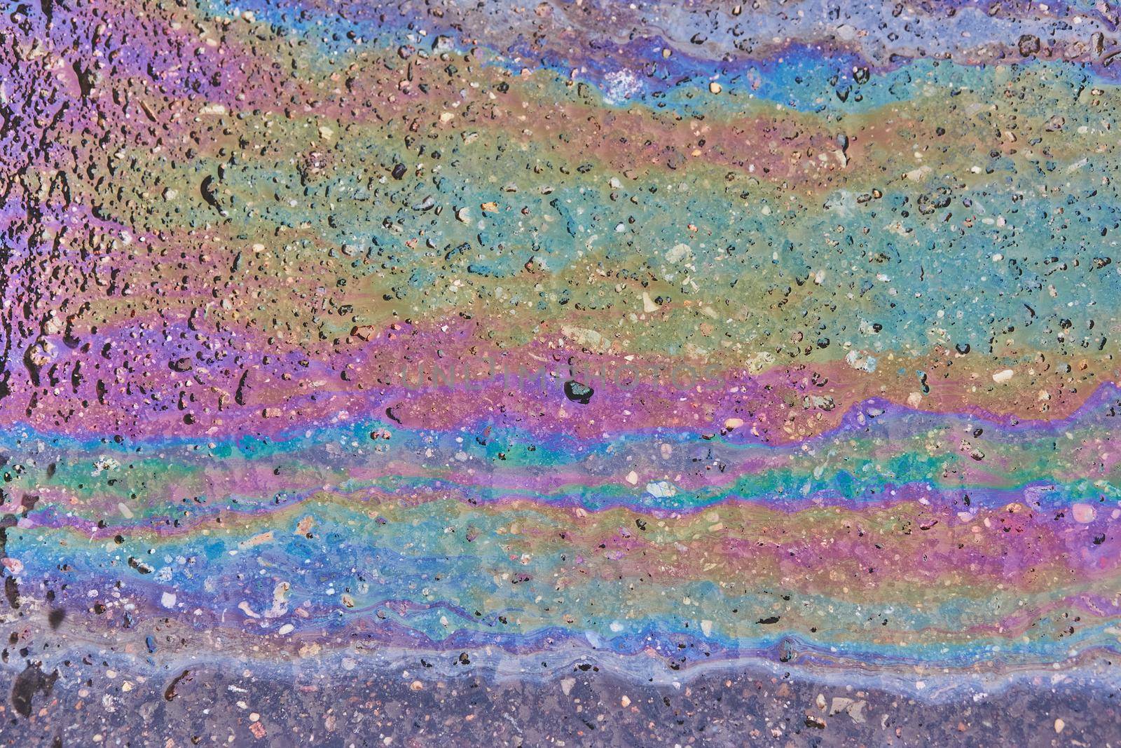 Oil stain on Asphalt, color Gasoline fuel spots on Asphalt Road as Texture or Background