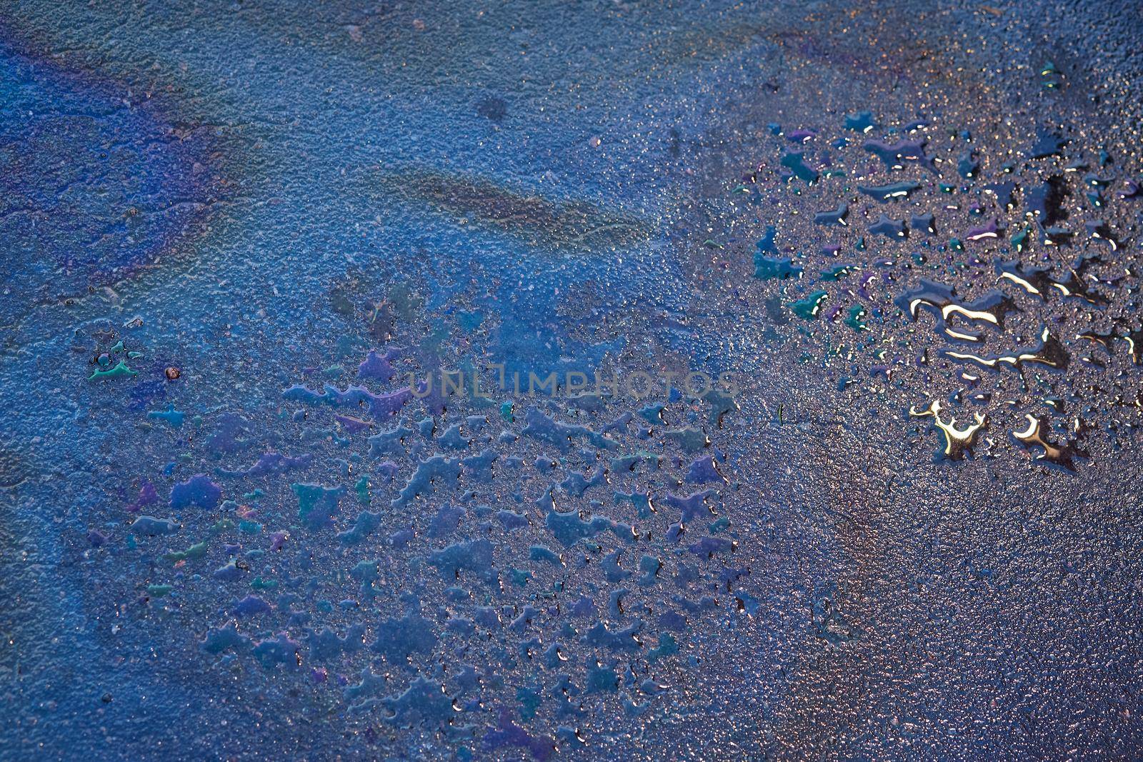Oil stain on Asphalt, color Gasoline fuel spots on Asphalt Road as Texture or Background.Close-up Oil stain on Asphalt