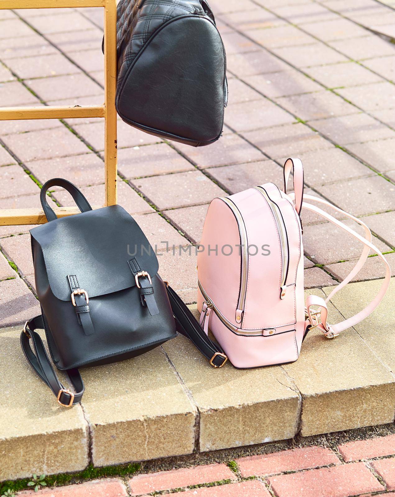 school bags backpacks are on the sidewalk