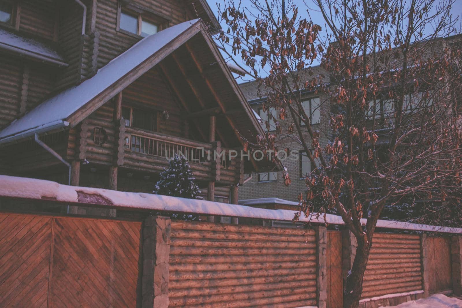 Old wooden house in winter with photo filter
