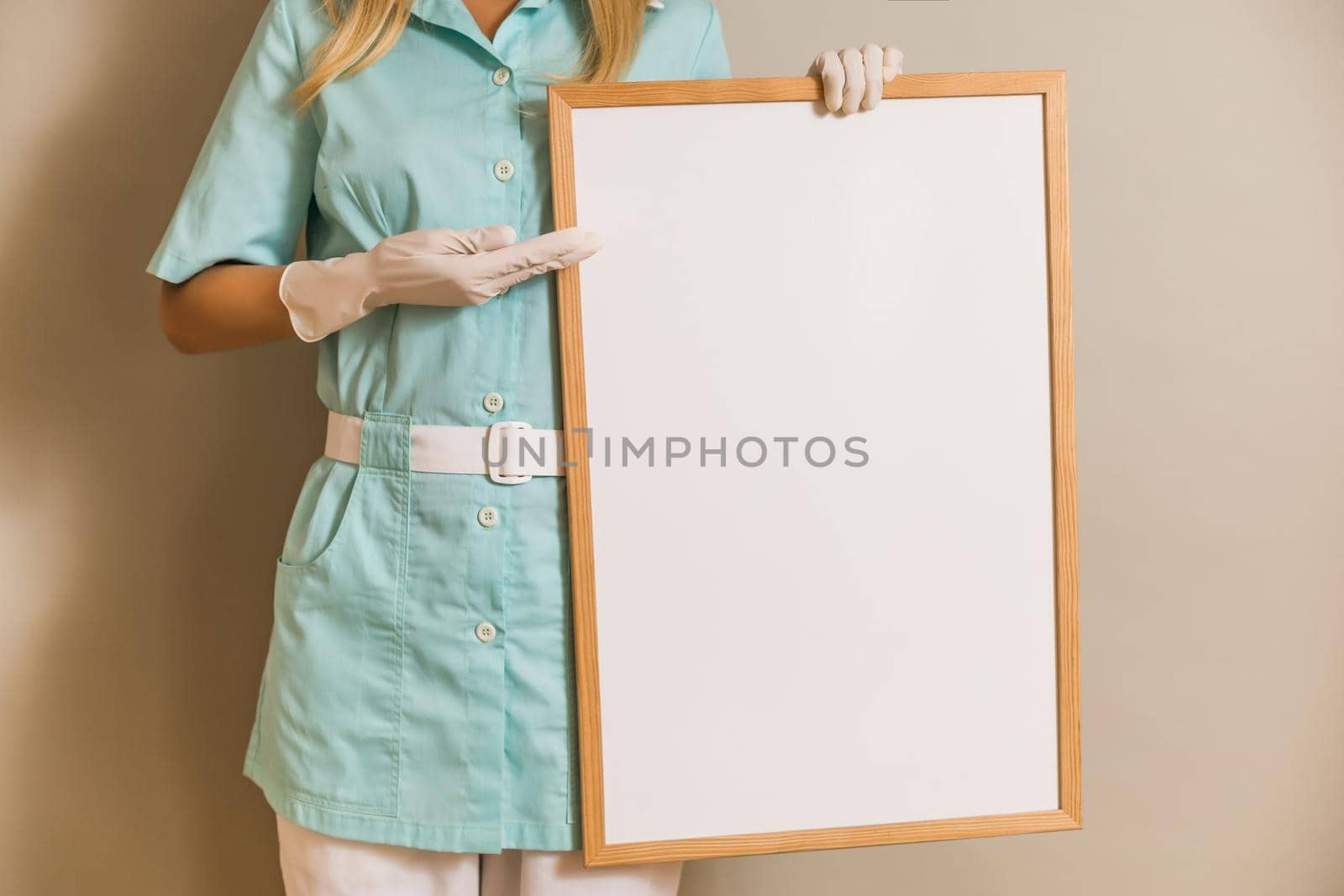 Image of medical nurse holding whiteboard.