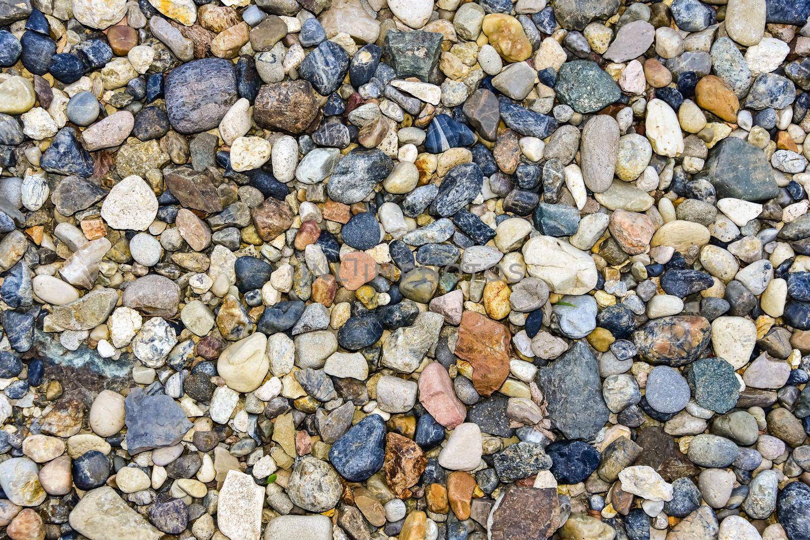 Rocks sea beach or stones background, Top view many small stones in assorted colors, Abstract rough wallpaper nature concept.