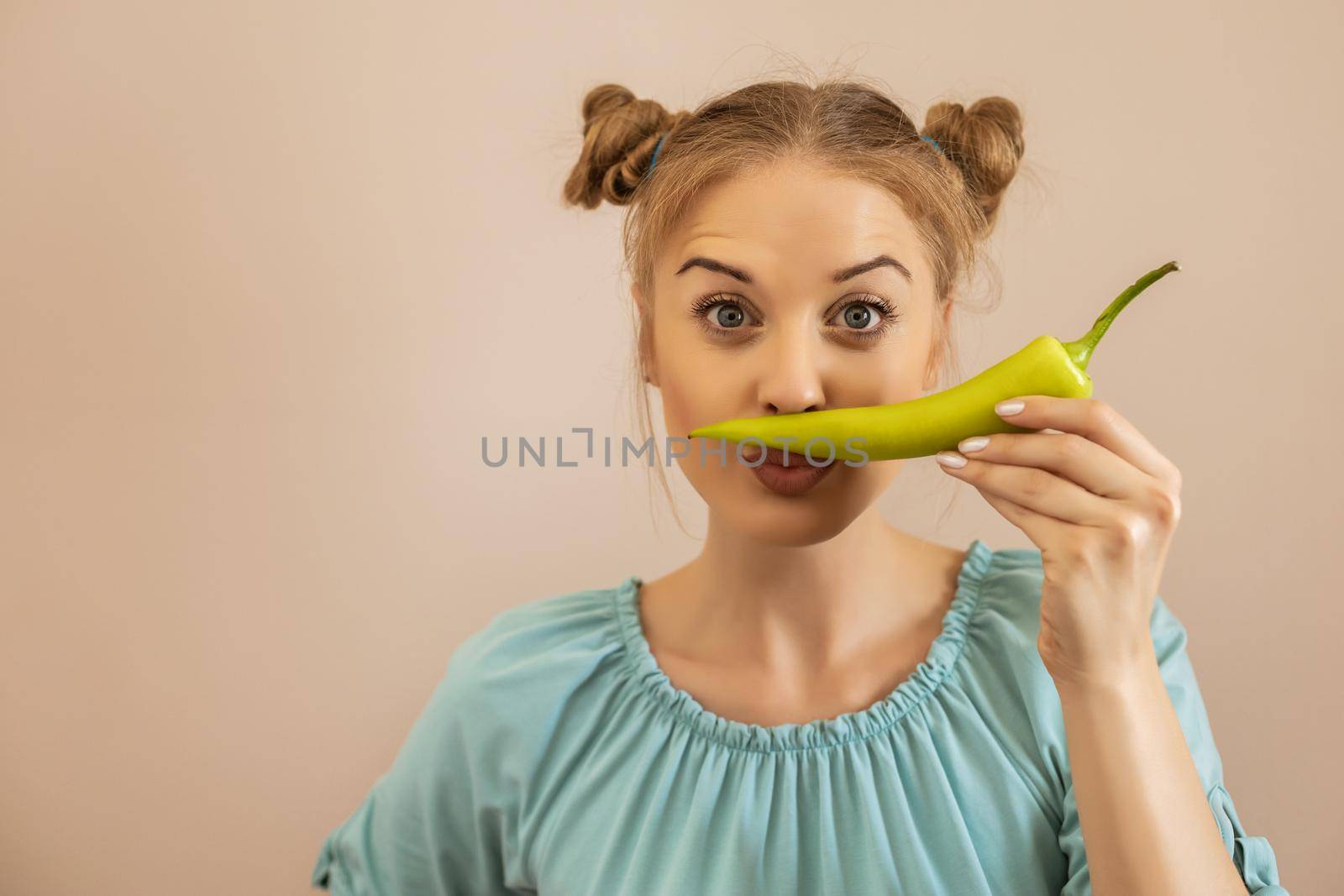 Woman holding green pepper by Bazdar