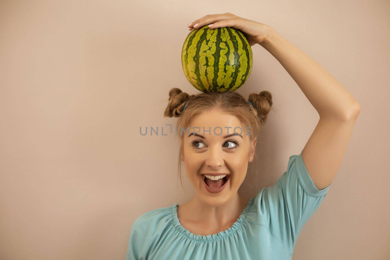Woman holding  watermelon on her head by Bazdar