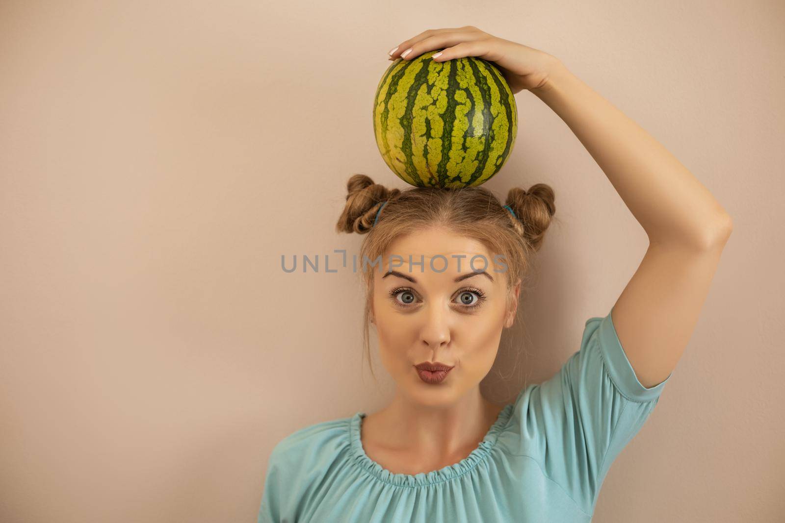 Woman holding  watermelon on her head by Bazdar