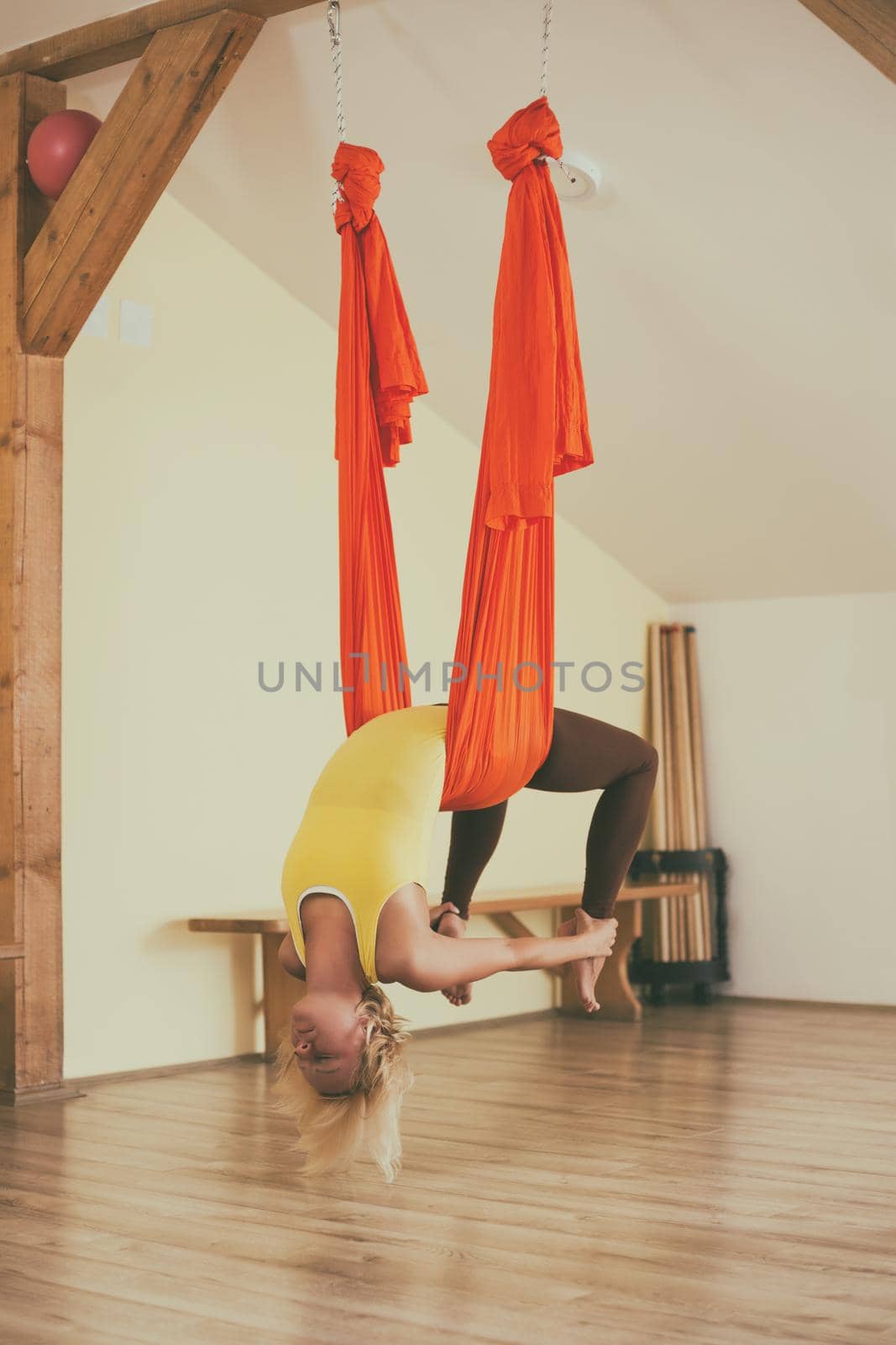 Woman doing aerial yoga by Bazdar