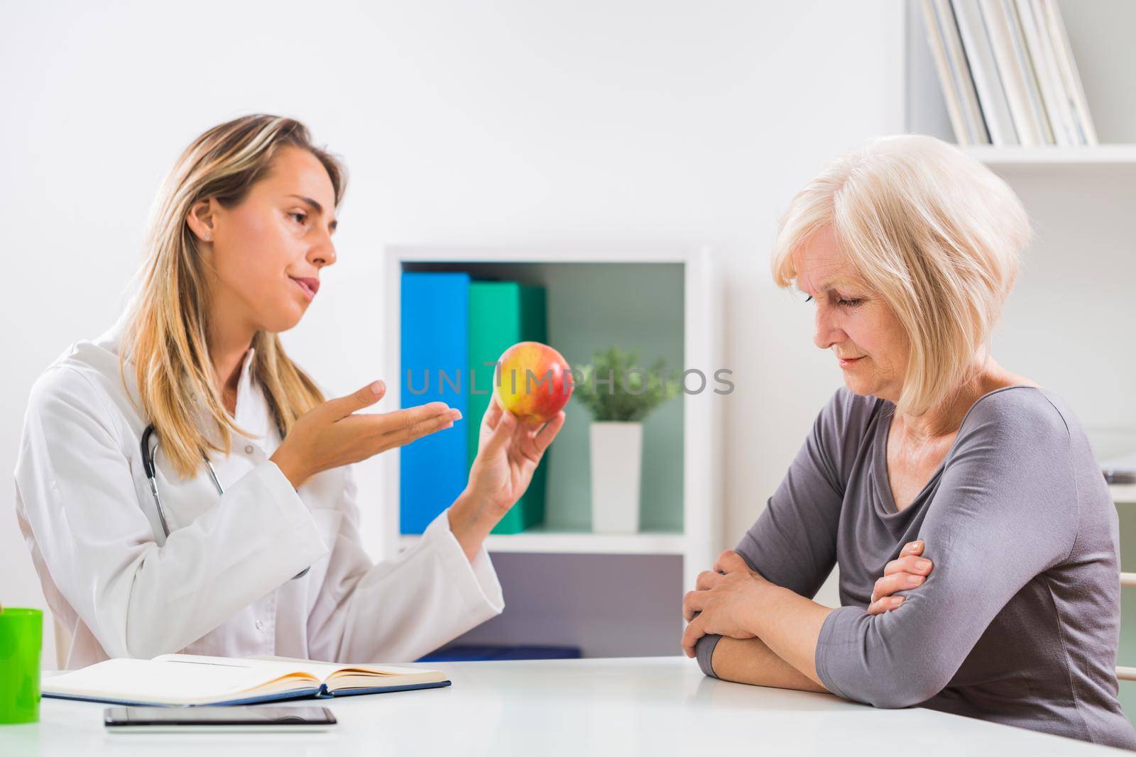 Senior woman patient refusing to eat fruit by Bazdar