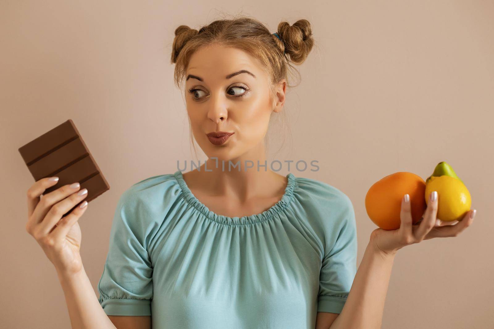 Cute woman having doubts with healthy and unhealthy eating.Toned image.