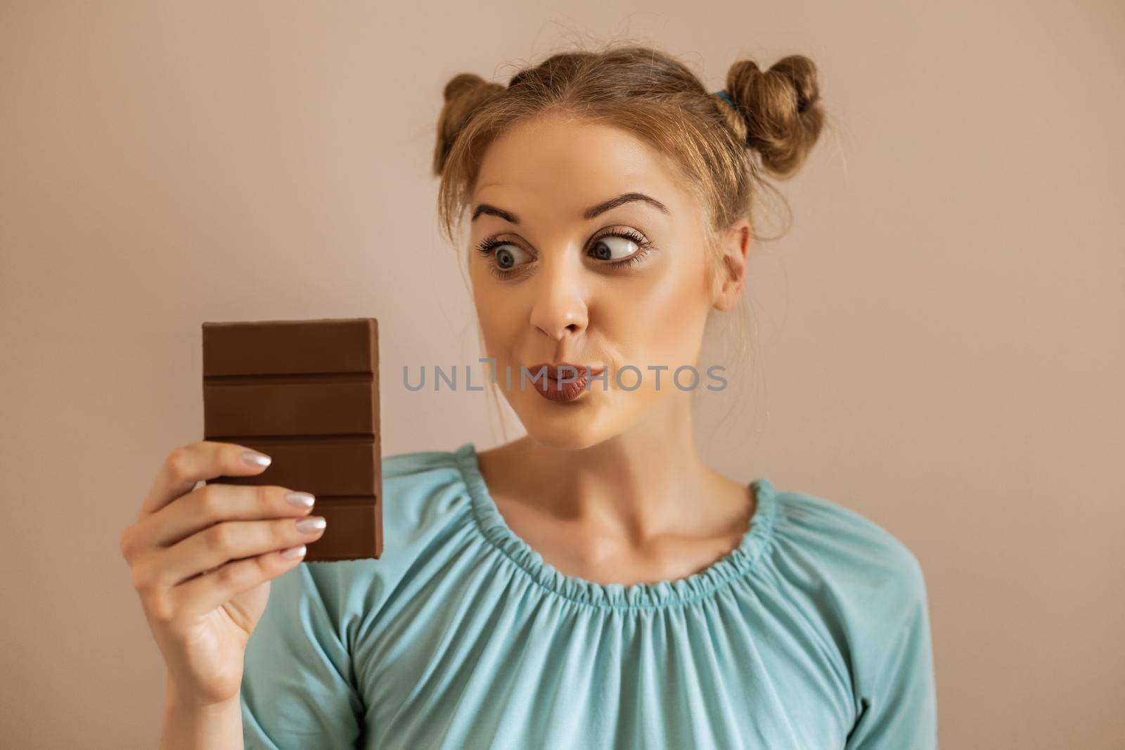 Portrait of cute woman looking with desire at  chocolate.Toned image