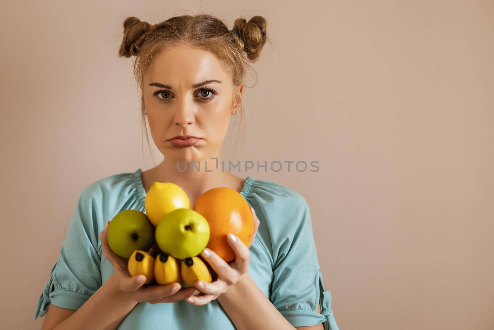 Cute woman is tired of dieting and  eating fruit.Toned image.