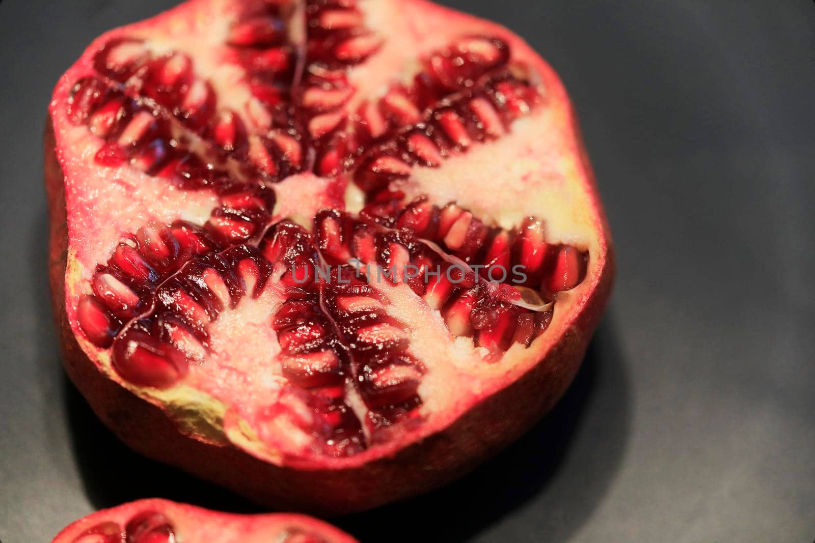 Fresh pomegranate, half cut an full fruit