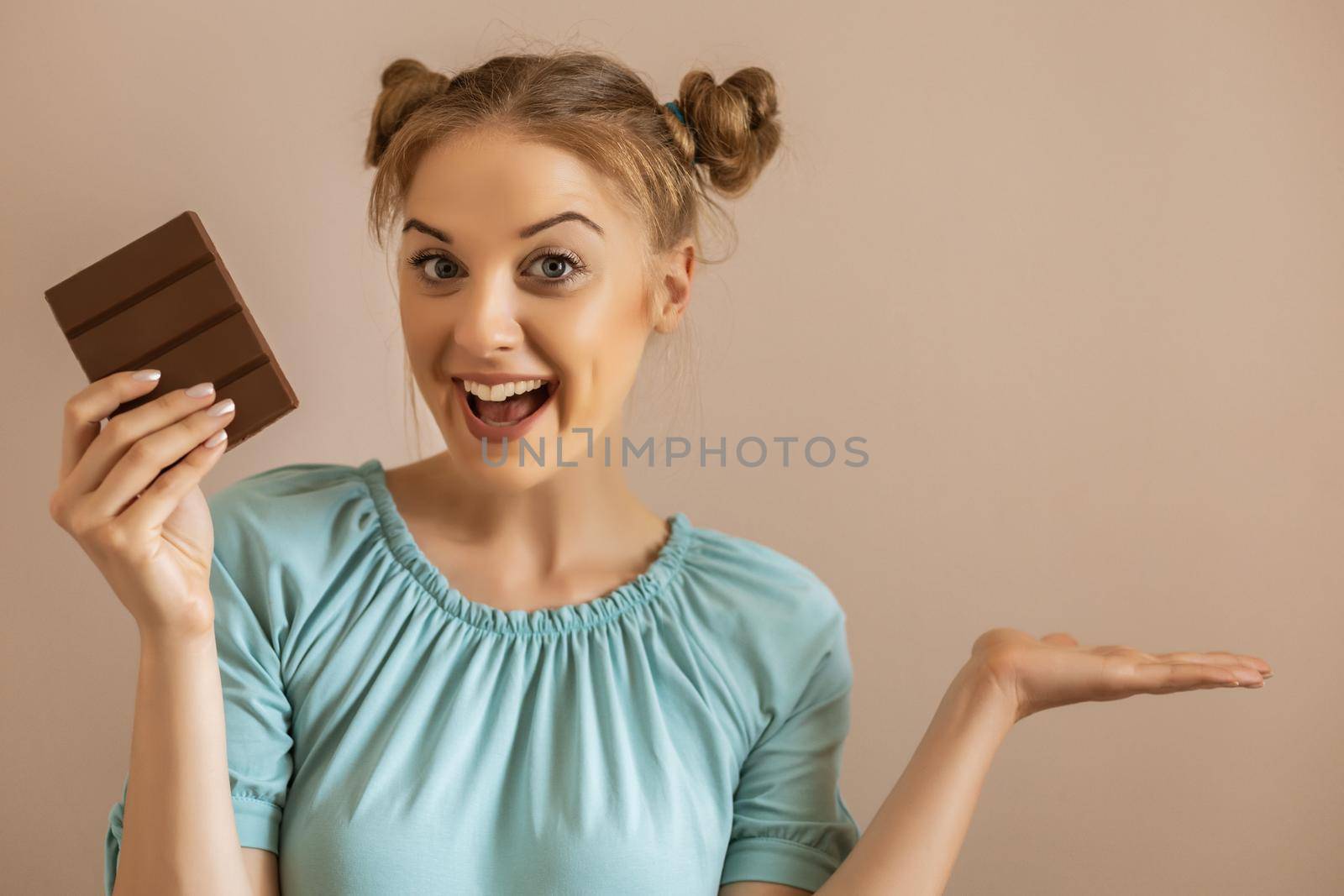 Portrait of happy cute woman enjoys eating chocolate.Toned image.