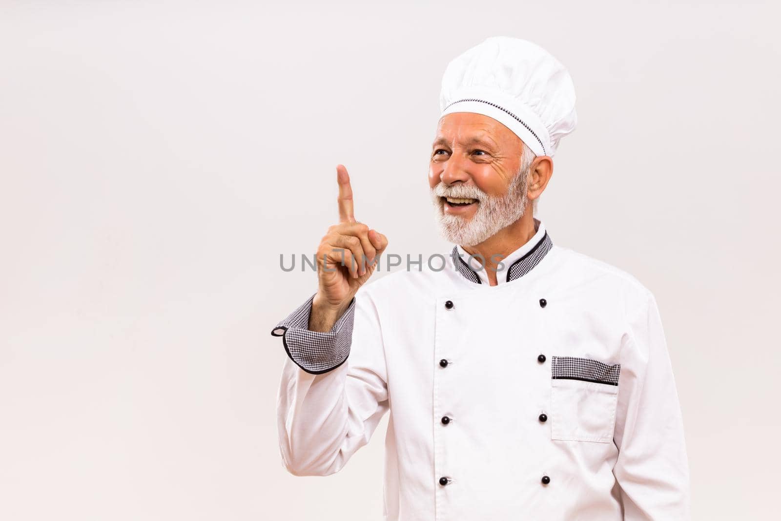 Portrait of happy senior chef having idea.