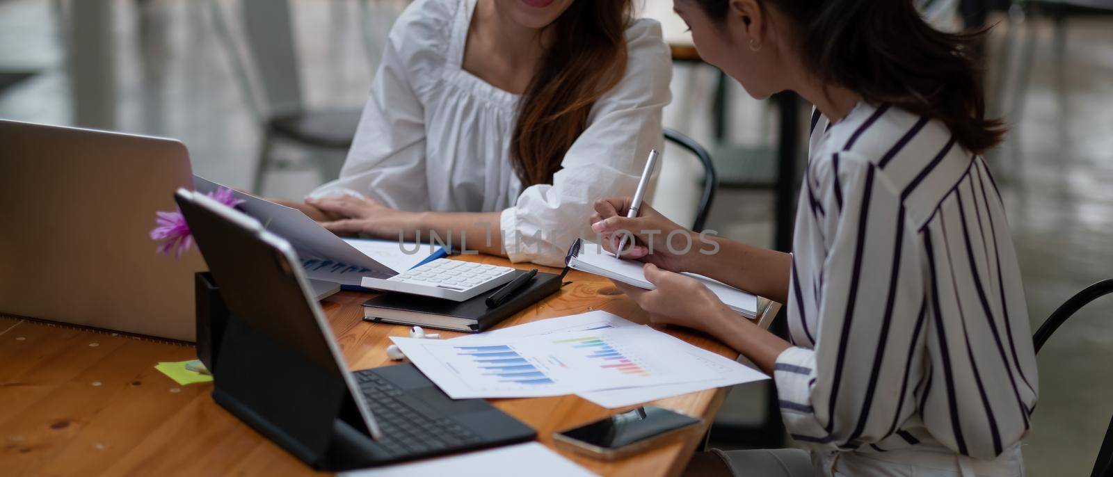 Business People Meeting to discuss and brainstorming the financial report paperwork in home office. Financial advisor teamwork and accounting concept.