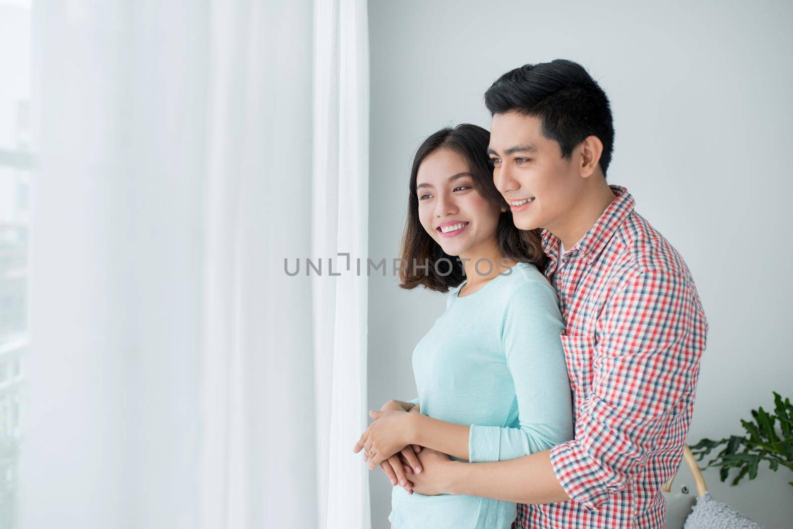 Romantic happy young asian couple relax at modern home indoors