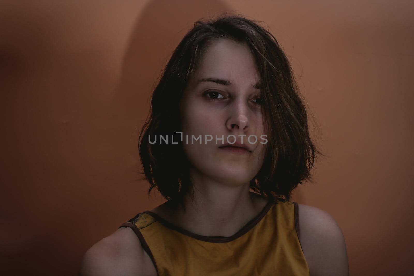Dark portrait of serious young woman