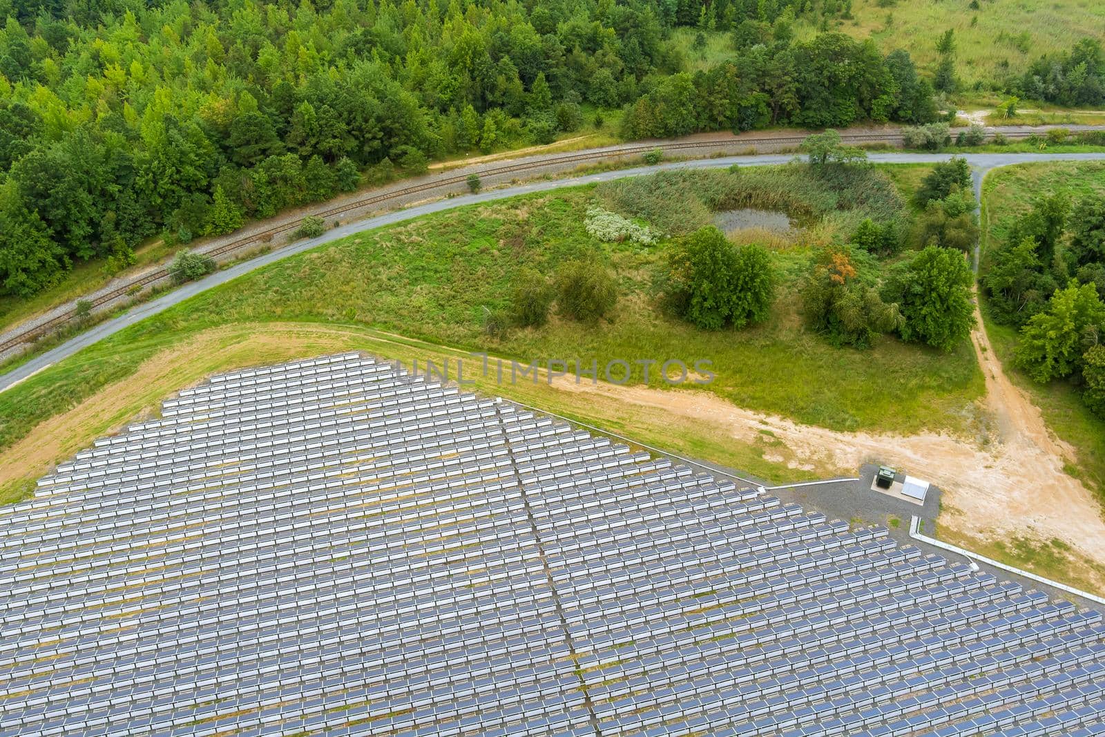 Amazing aerial view of solar panels stand in a row in green energy landscape electrical power by ungvar