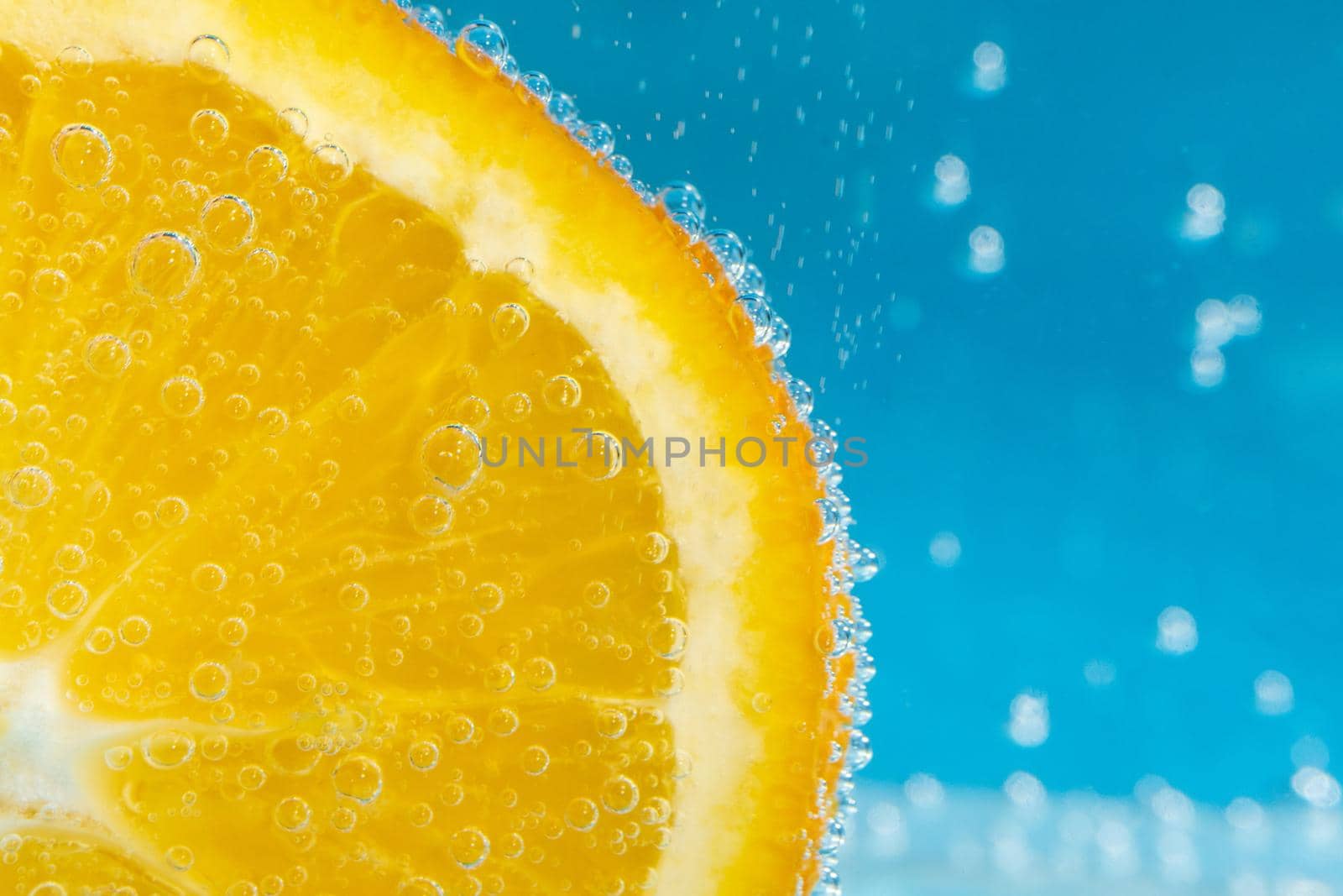 orange fruit in the water close-up macro. Refreshing grapefruit drink, cocktail. by darksoul72