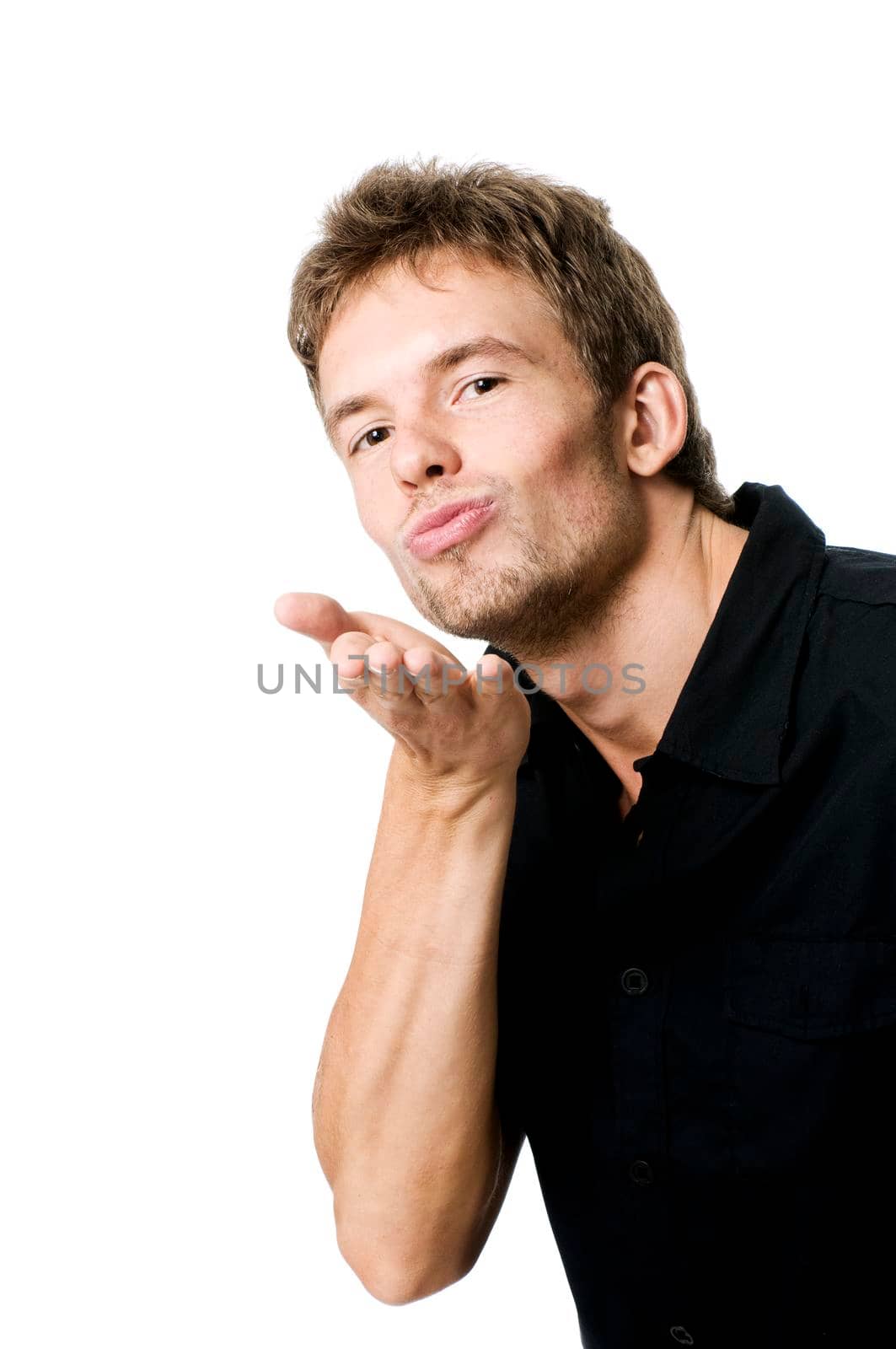 Young man isolated on white sending a kiss