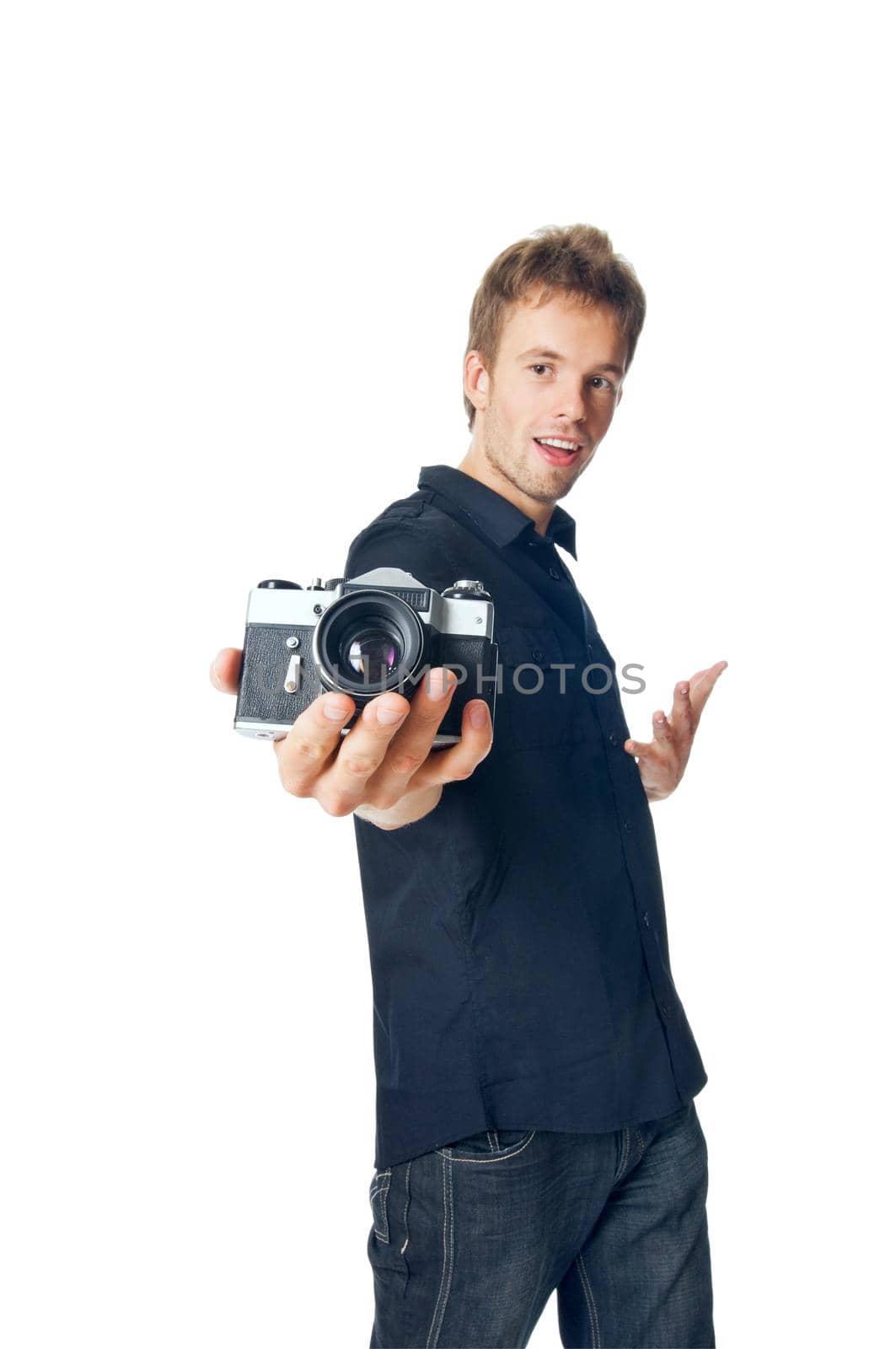 Young man standing with film camera isolated on white background