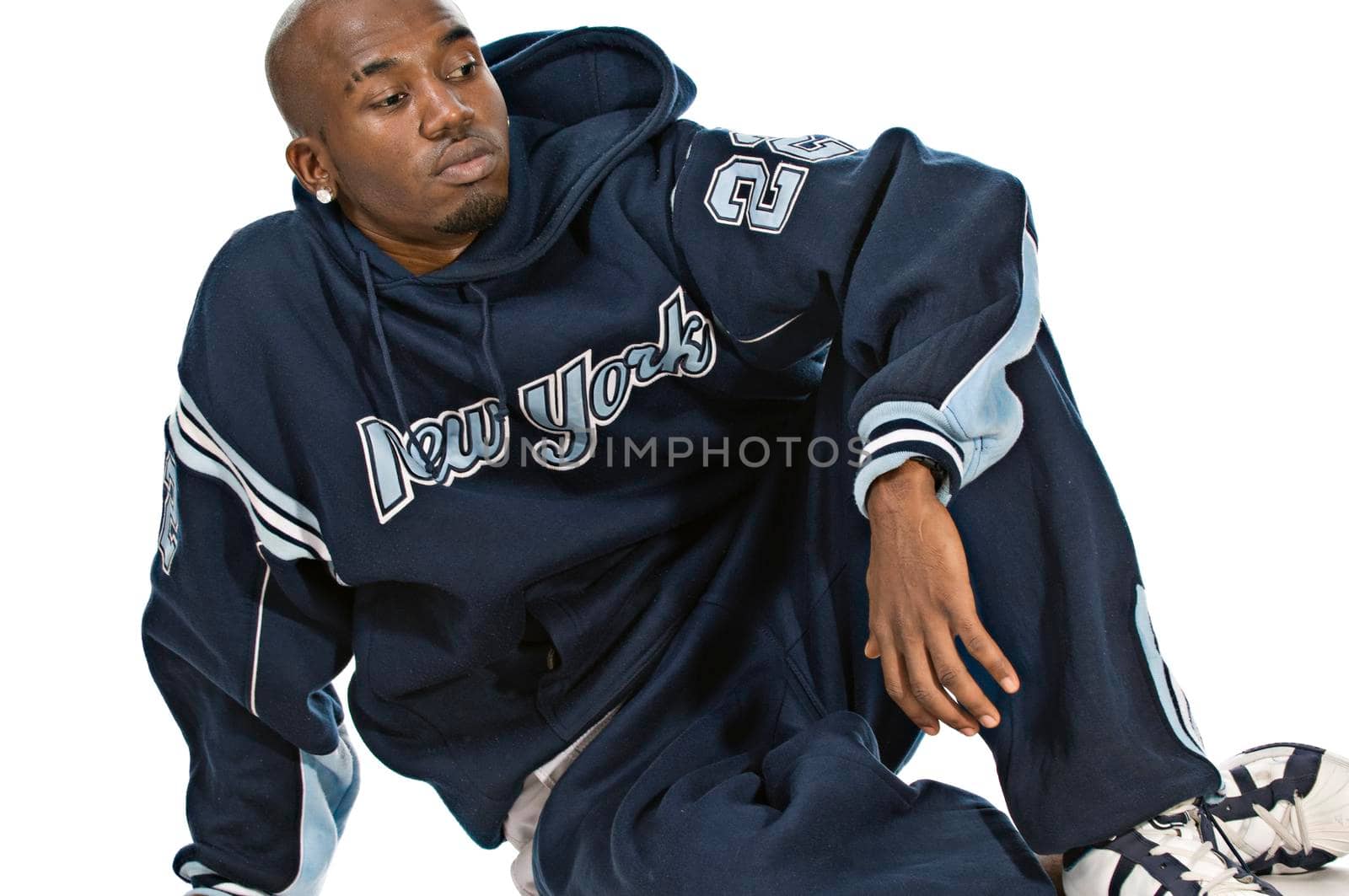 Cool young hip-hop dancer on white background