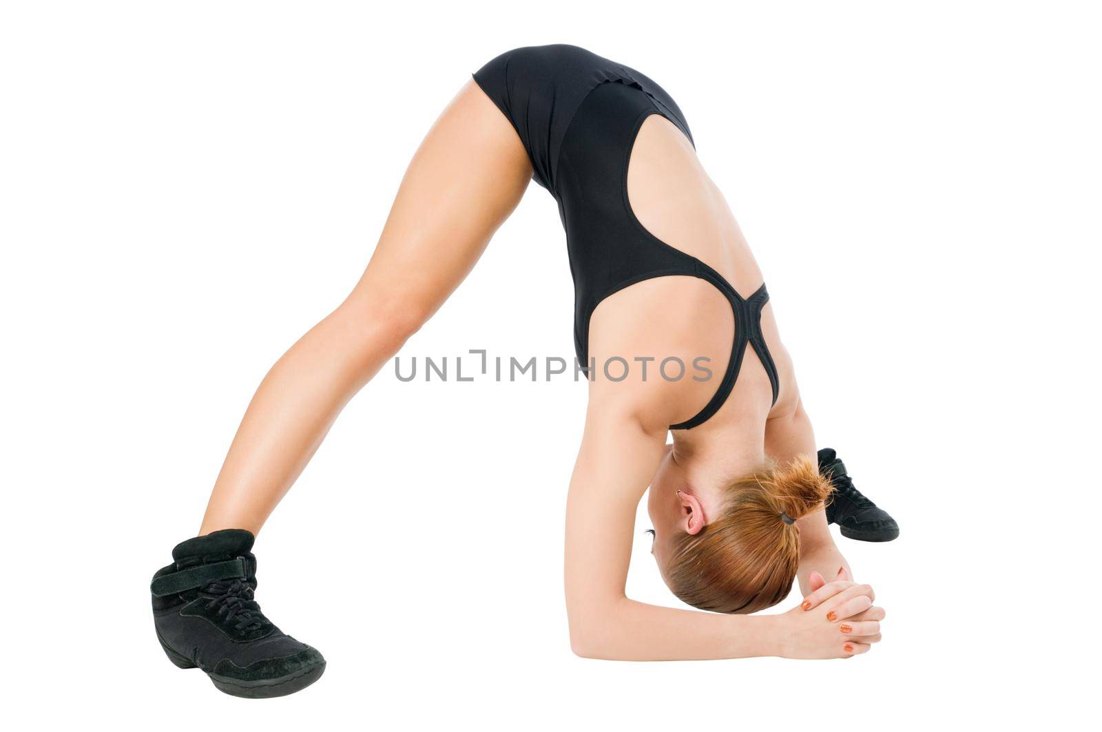 Beautiful fit red girl practicing yogatic pose or fitness exercises
