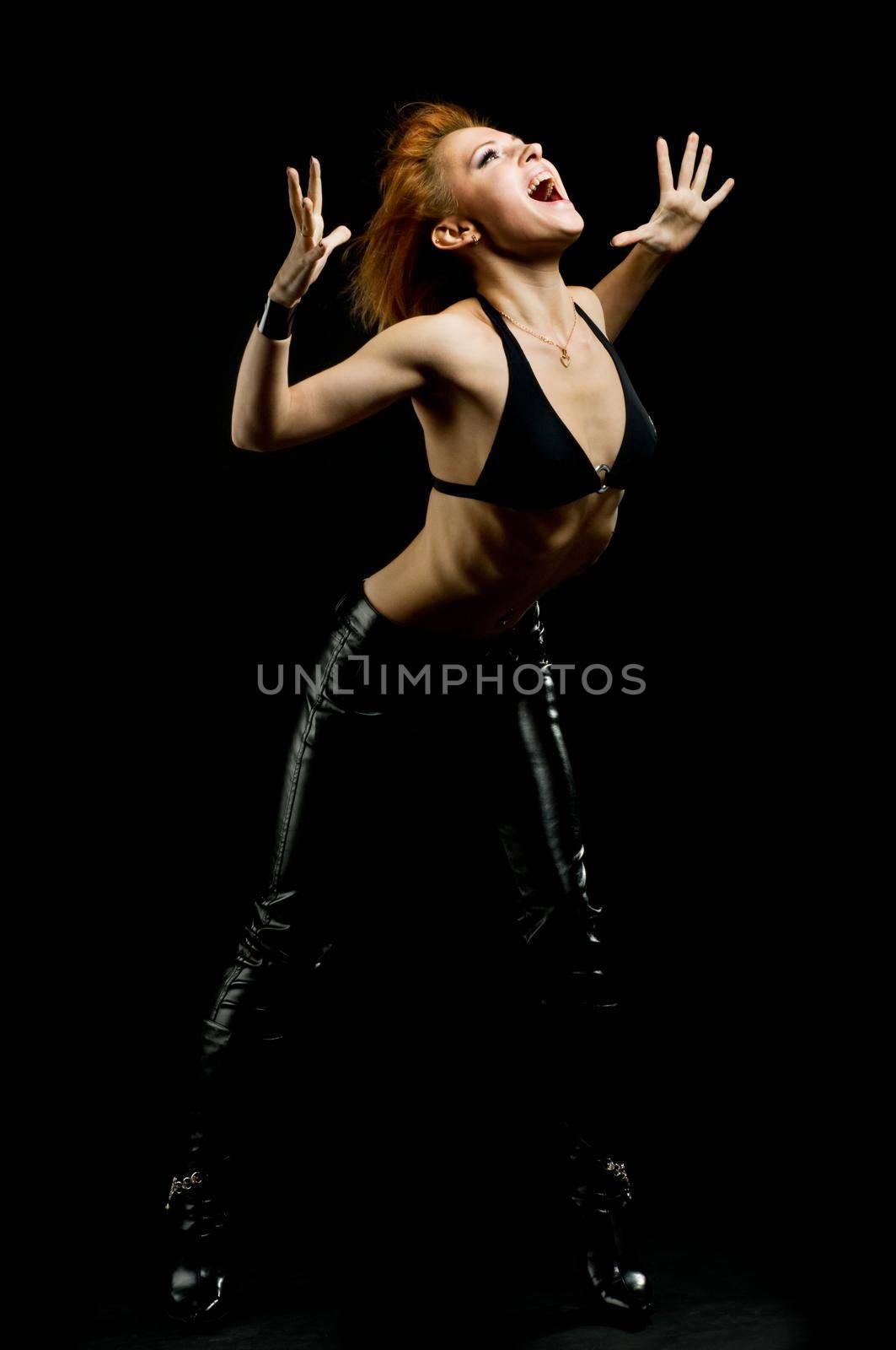 Studio shot of shouting girl on black background