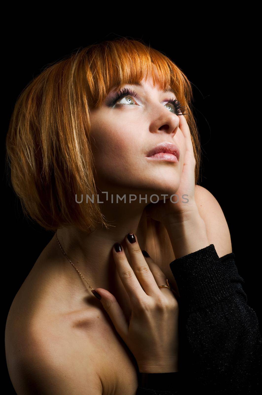 Studio shot of beautiful red girl on black background