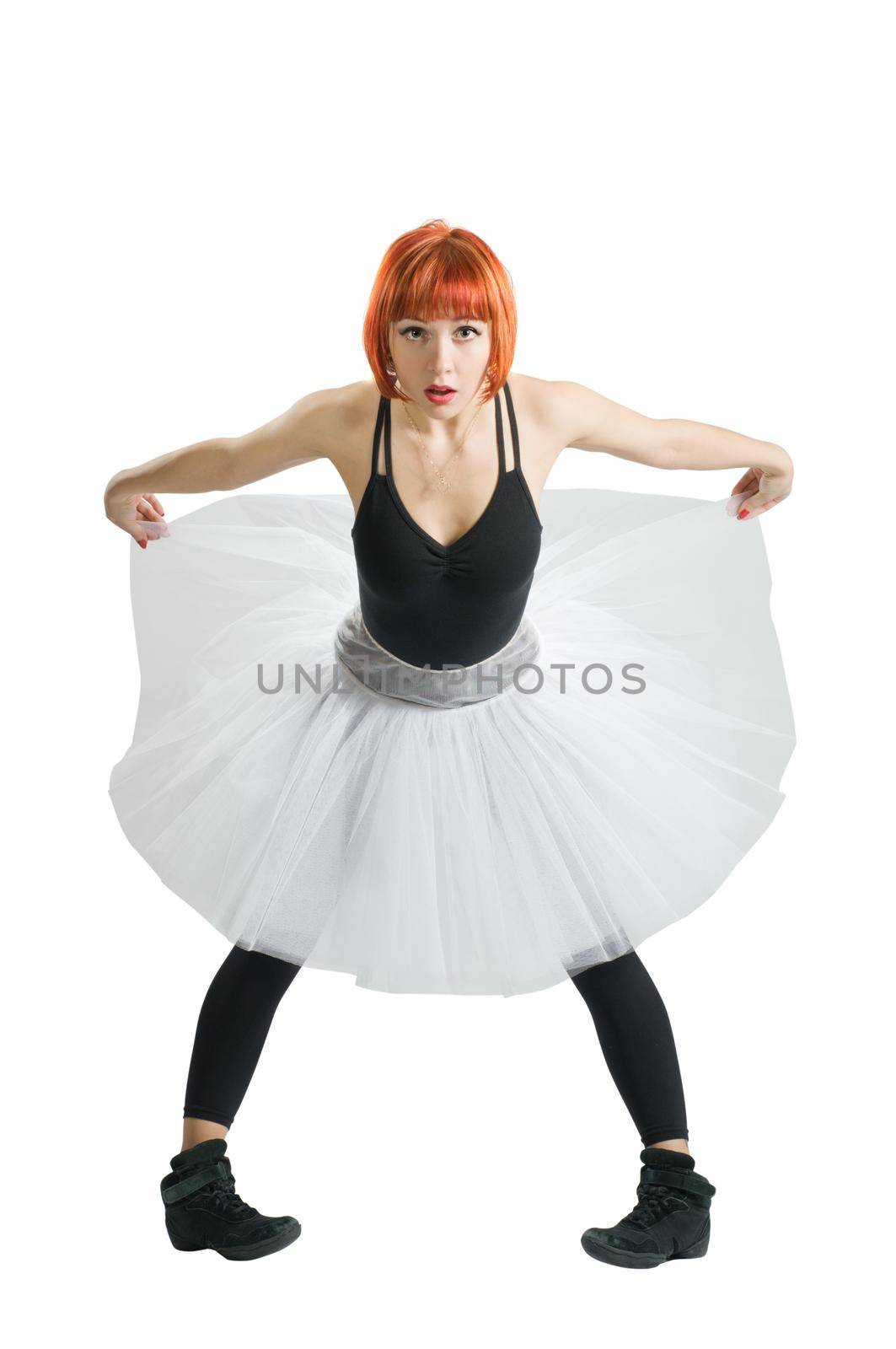 Beautiful red-haired ballerina wearing tutu on white background