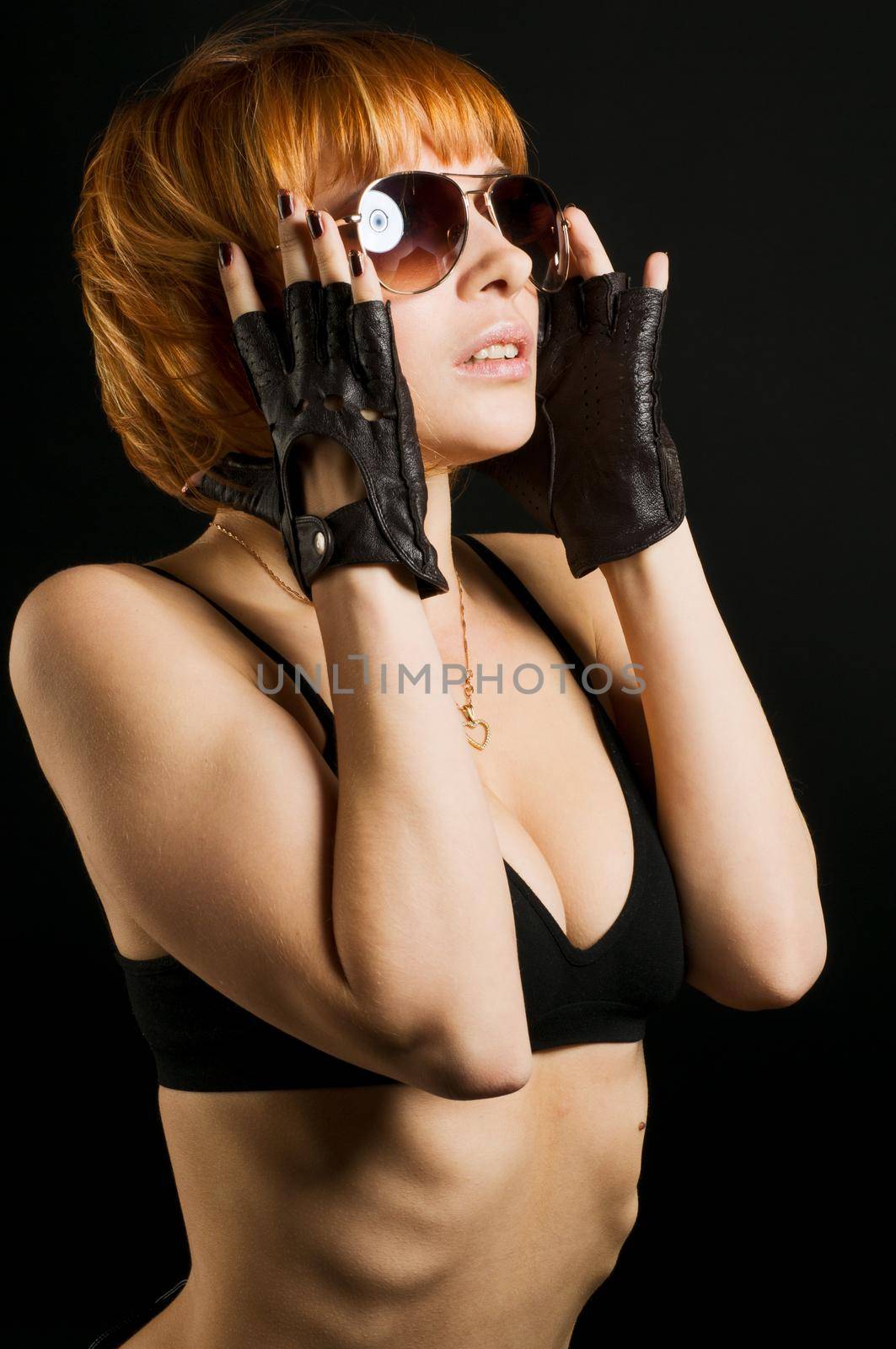 Studio shot of beautiful red girl on black background