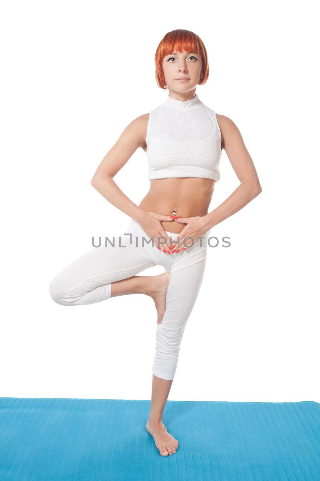 Beautiful red-haired girl practicing yoga or callanetics on white background