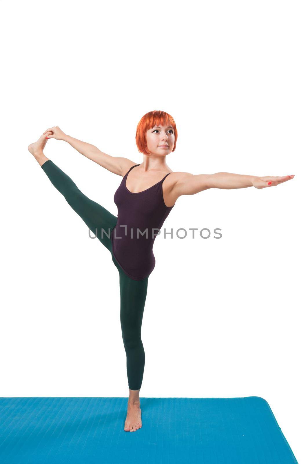 Beautiful red-haired girl practicing yoga or callanetics on white background