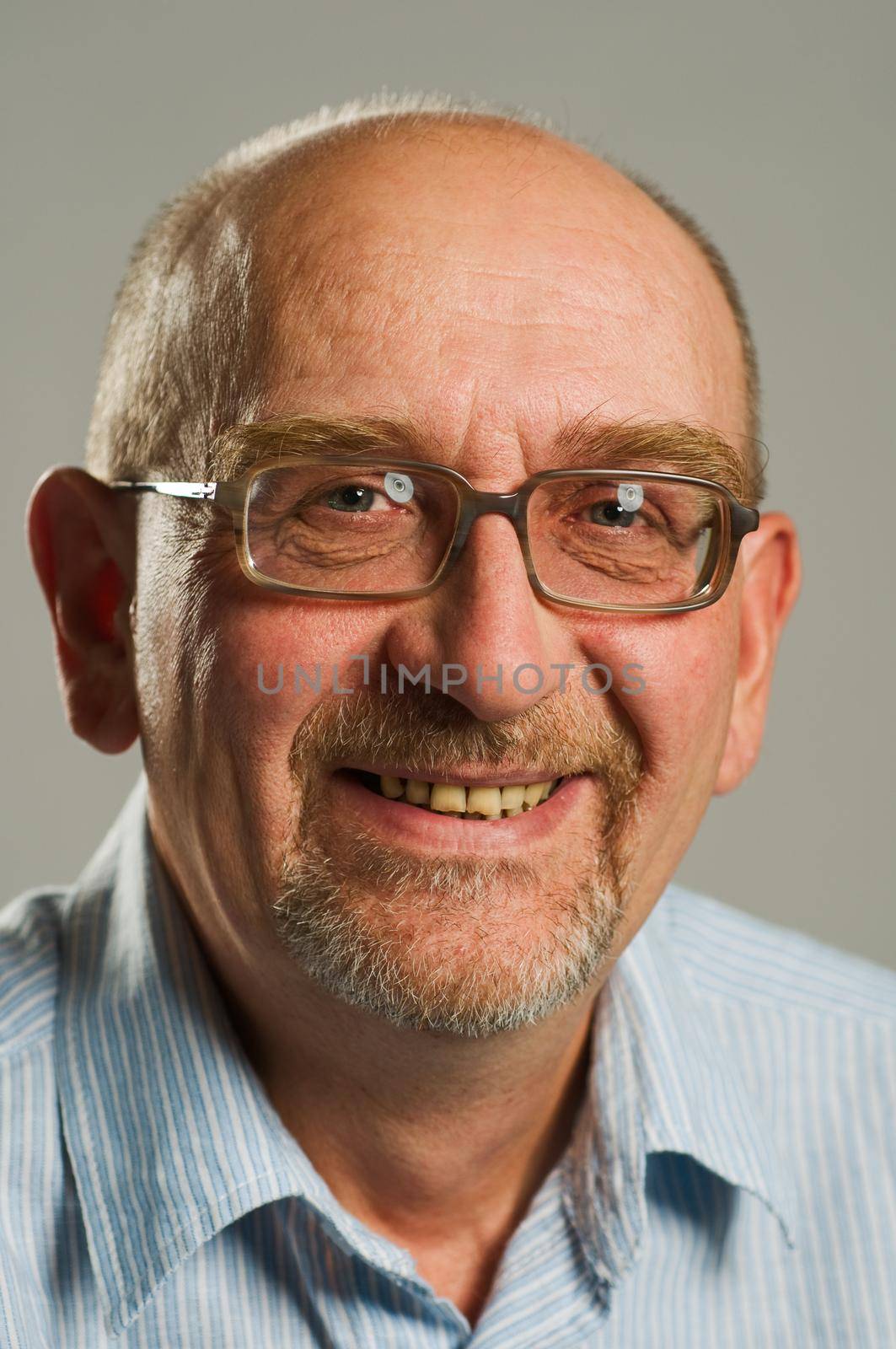 Handsome mature man posing on plain background