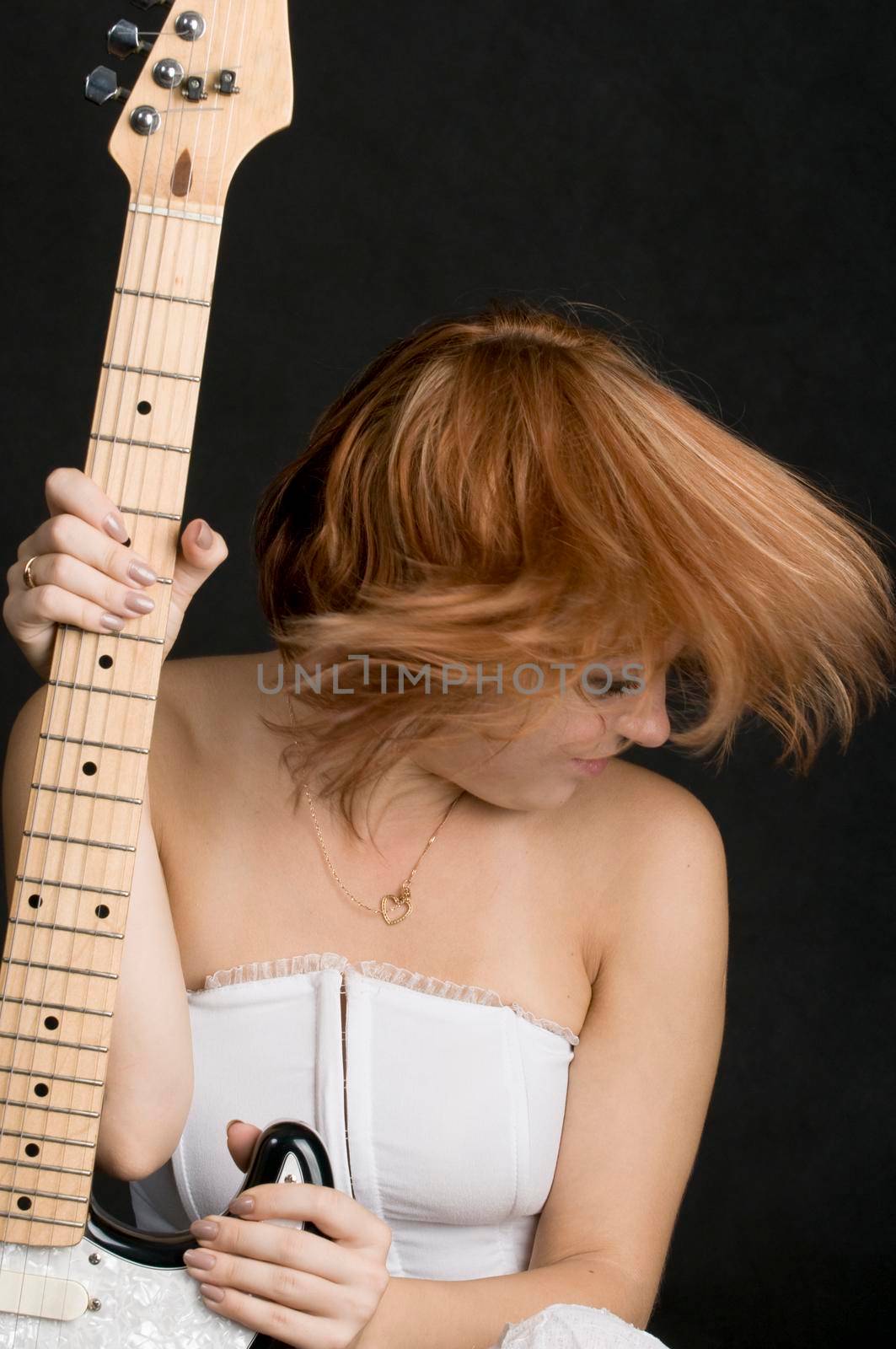 Portrait of a beautiful red haired girl on black background