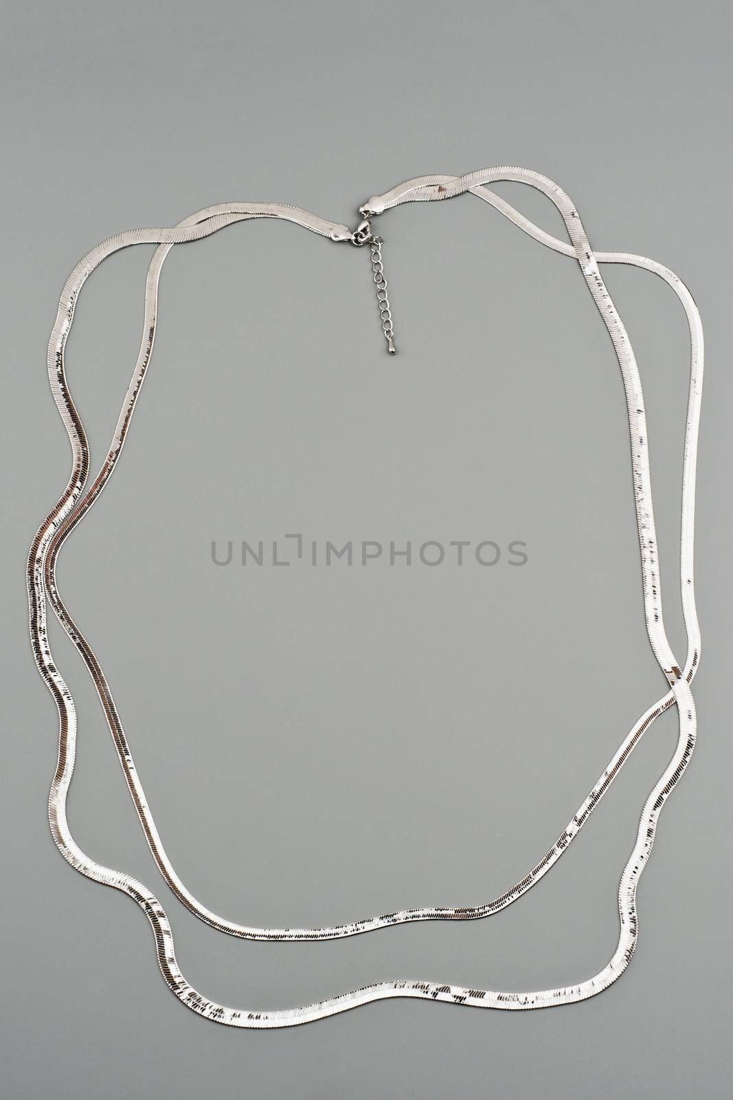 Luxury silver necklace on gray background