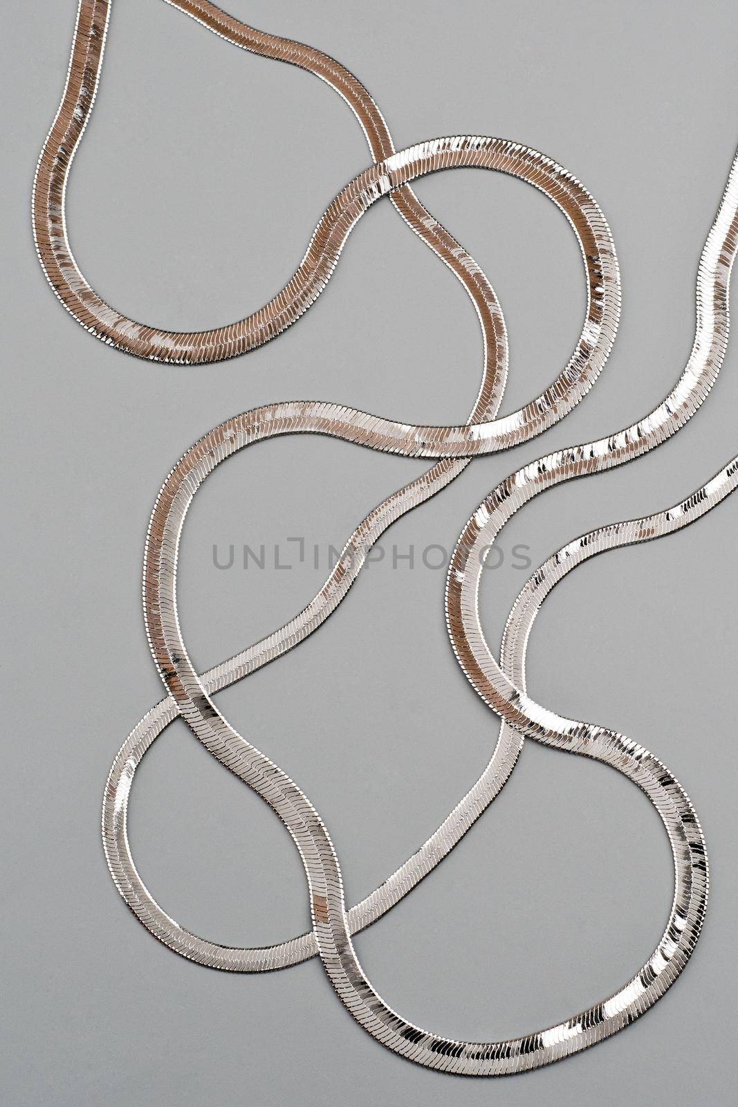 Luxury silver necklace on gray background