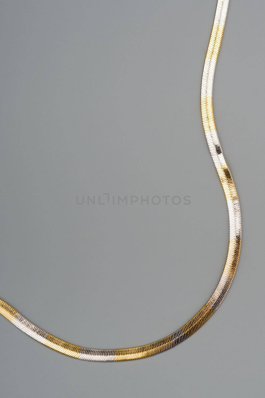 Luxury golden necklace on gray background