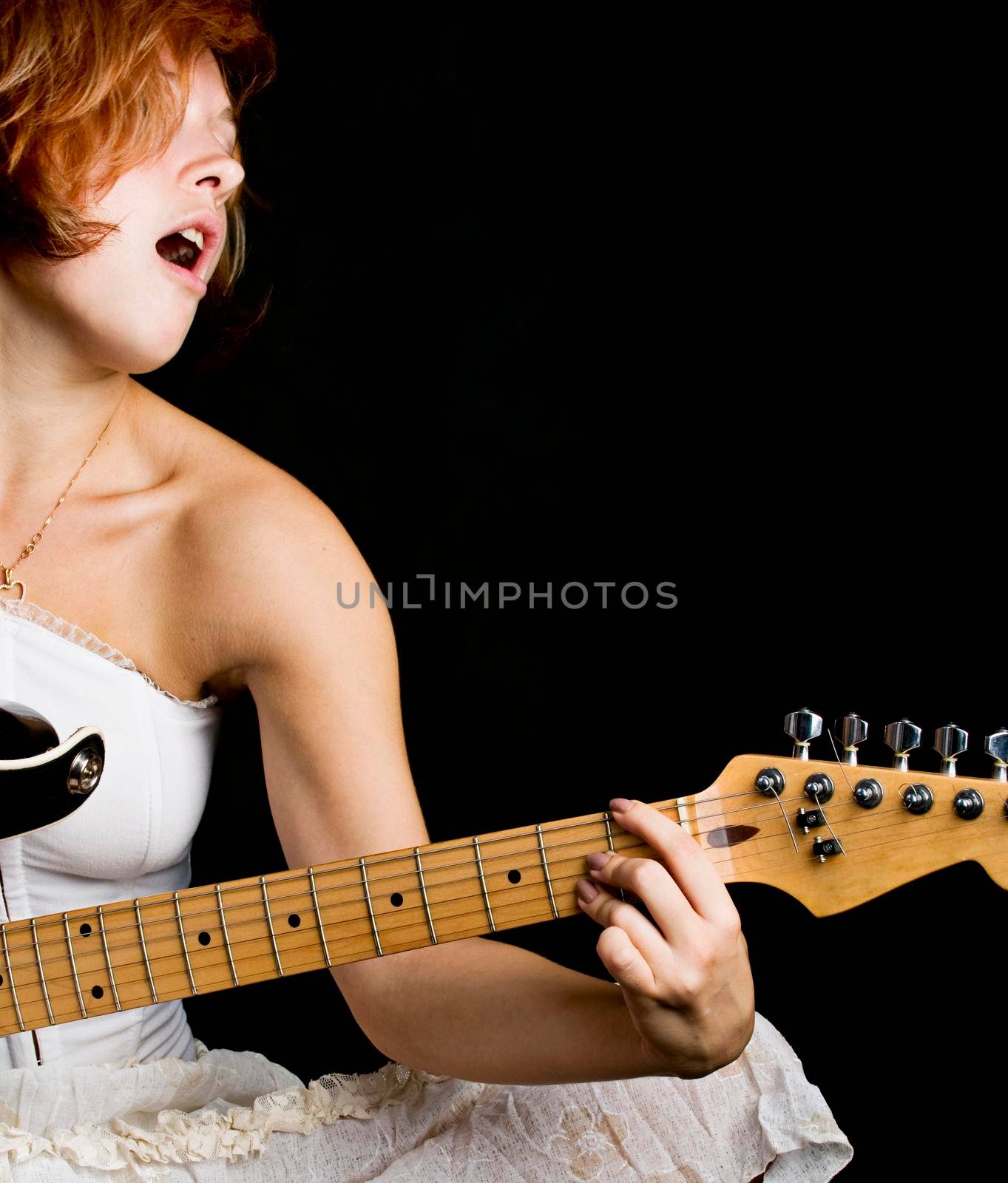Portrait of a beautiful red haired girl on black background