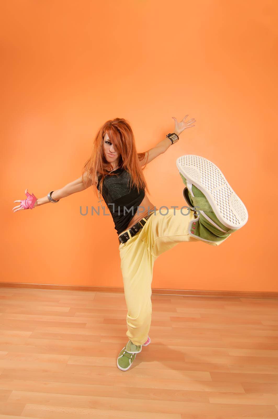 Modern dancer poses in front of the vivid background