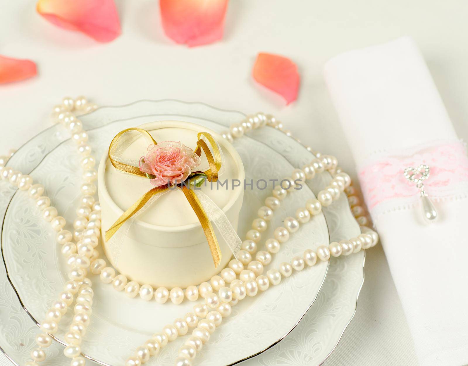 Pearls and flower petals at a decoration for wedding table