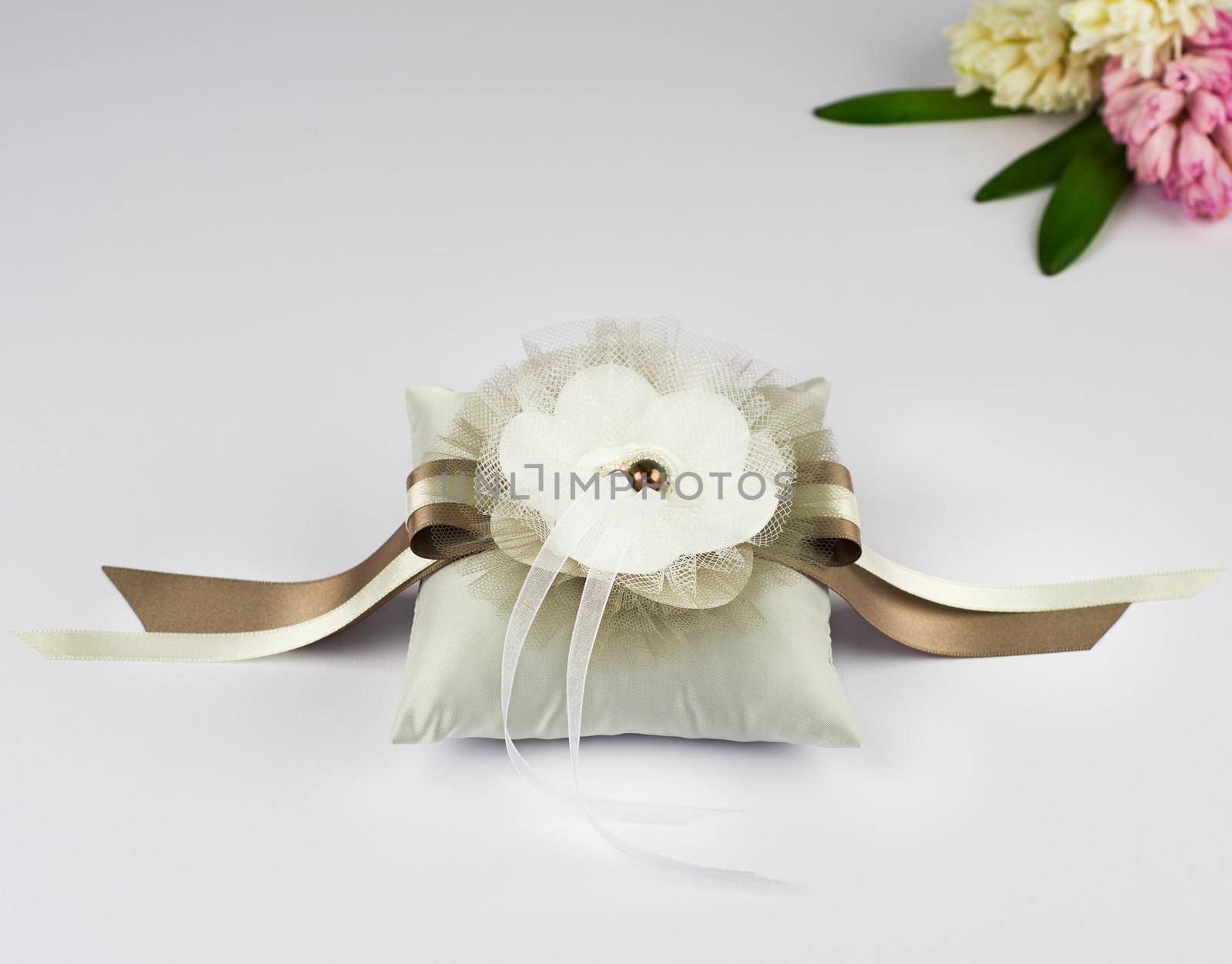 Exquisite pillow for wedding rings on gray background