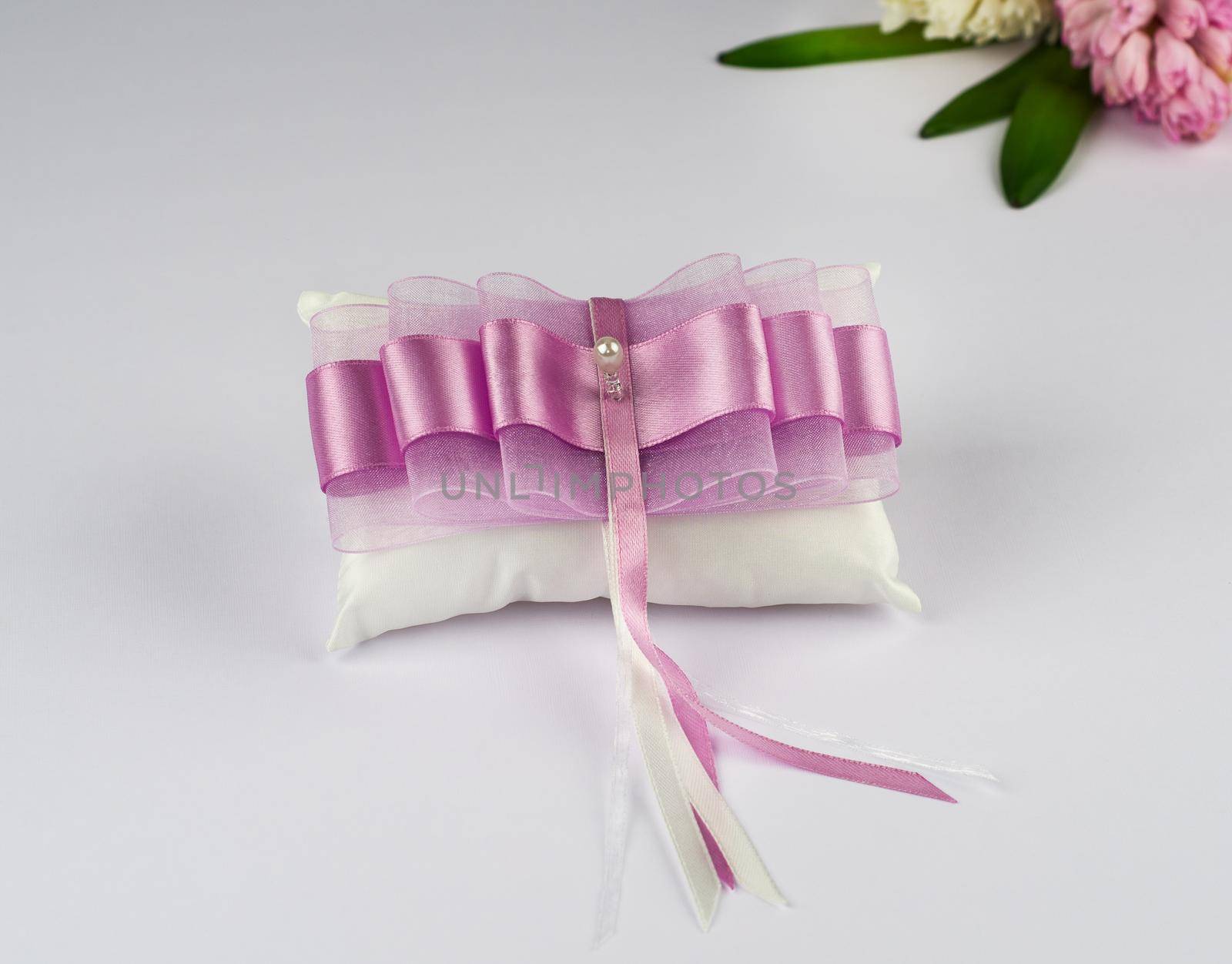 Exquisite pillow for wedding rings on gray background