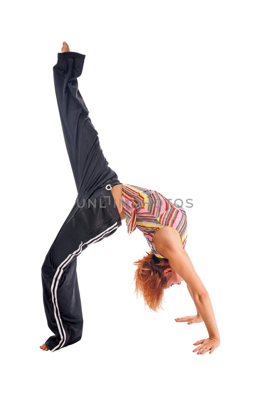 Red haired girl performing fitness exercises on white background