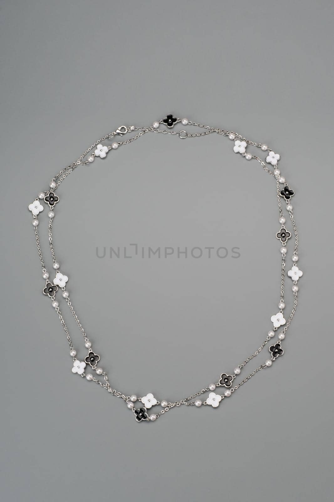 Beautiful fashion jewellery necklace bracelet on gray background