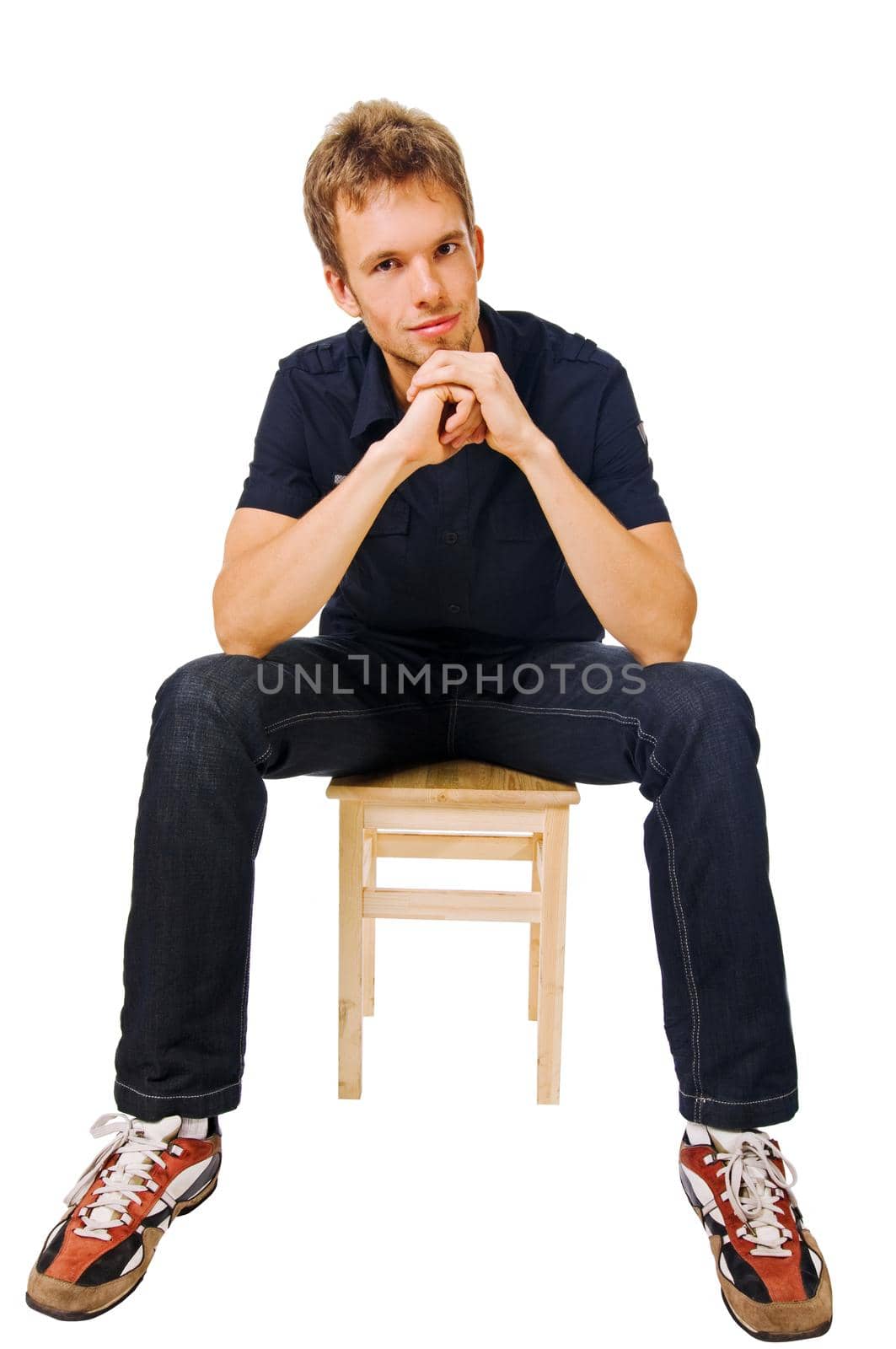 Fit young man sitting isolated on white