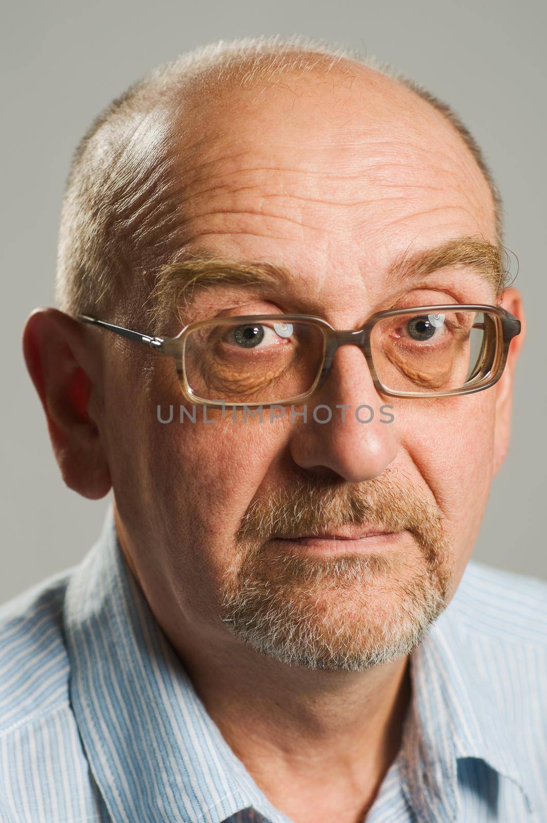 Handsome mature man posing on plain background