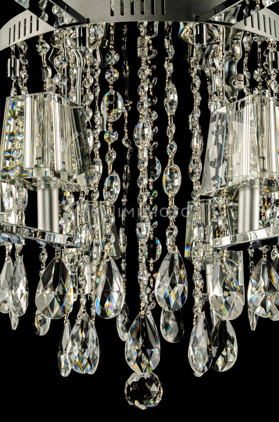 Closeup of contemporary glass chandelier isolated over black background